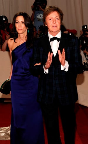 Recording artist Paul McCartney, right, and Nancy Shevell arrive at the Metropolitan Museum of Art Costume Institute gala in New York on May 2. McCartney will be honored as MusiCares person of the year during Grammy week next year. (The Associated Press/File)