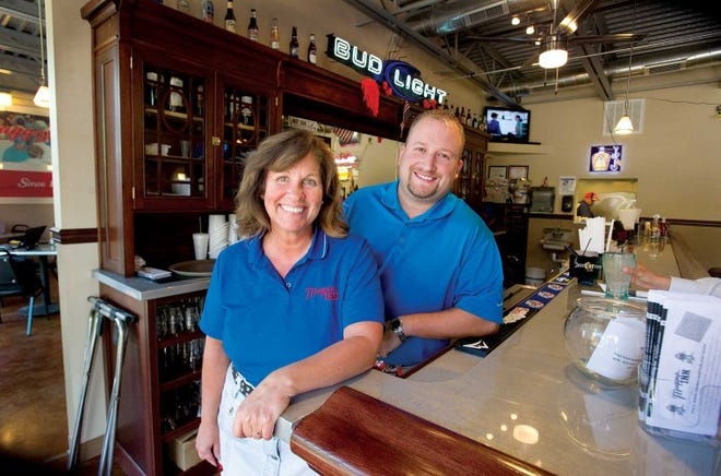 Muggsy's Inn manager Debbie Houghton-Brunick and co-owner Ryan
Seybold stand at the bar of the new Historic Arkansas Riverwalk of
Pueblo restaurant Monday. The restaurant reflects a longtime
Bessemer tavern that closed in 2004.