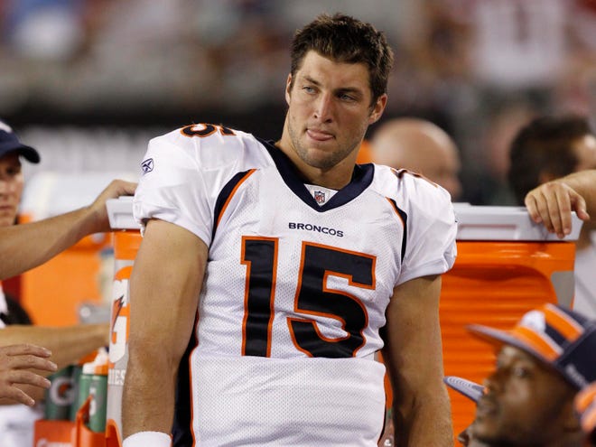Tim Tebow remained on the bench despite the offensive struggles of the Denver Broncos in Monday night's 23-20 loss to Oakland. (Photo by The Associated Press)