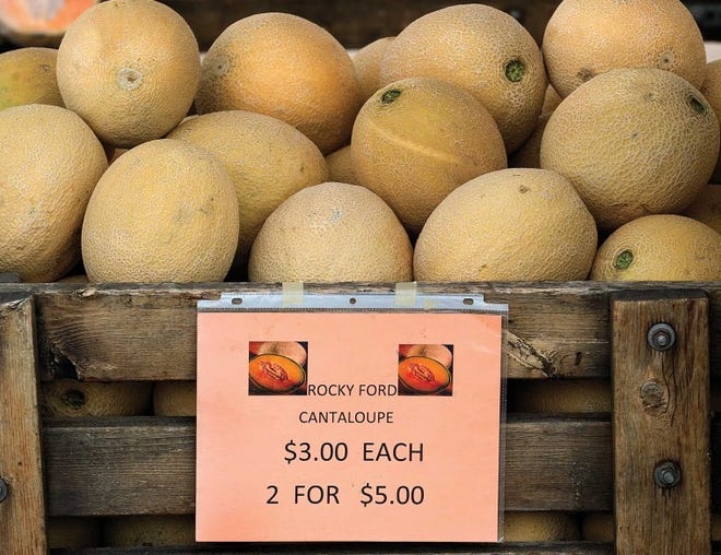 A sign advertises Rocky Ford cantaloupe for sale Tuesday at the
Rocky Ford-based Lusk Farm booth at the Pueblo Farmers Market.