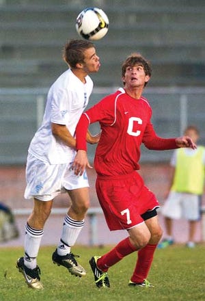 Pueblo West High School defender Jon Gjerde (left) heads the
ball away from Centennial's Jeff Shapiro during the first half of
Tuesday's game at the Cyclones' field.