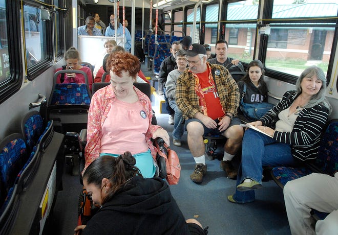 Columbia City Councilwoman Barbara Hoppe, right, waits to ride one of the Columbia Transit buses Thursday as the bus driver secures Kathleen Weinschenk’s wheelchair before beginning her route.