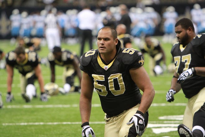 New Orleans Saints center Olin Kreutz warms up with the team.