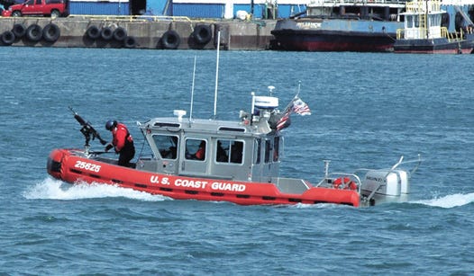 A U.S. Coast Guard crew responds during a training exercise Thursday to a mock bomb threat at the Soo Locks. Local, state and federal officials were joined by tribal authorities and Canadian authorities for two days of training on the St. Marys River.
