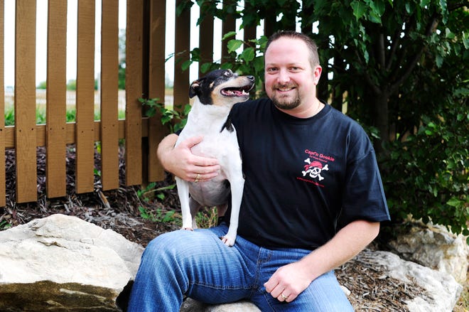 Jason Mains, pictured with his 8-year-old rat terrier, Montana, owns Capt’n Dookie, a pet waste removal company.