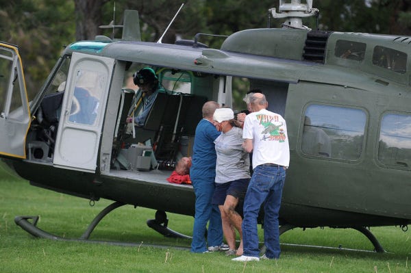 Medics help spectators injured in a crash during the National Championship Air Races in Reno, Nev. Emergency officials said 56 people were taken to hospitals in the area.