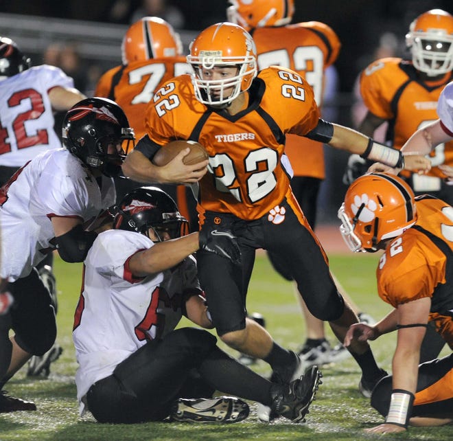 Oliver Ames Nicholas Cidado, center carries the football on the ground in the fourth quarter during their game, on September 16, 2011, in Easton.