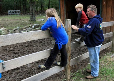 Photo by Sara Hudock-Cole/New Jersey Herald 
 
Nick Civitan and his children look over the paddock that used to house their pony, Pee-Wee. The small horse was attacked by a bear early Friday and later perished from his wounds.