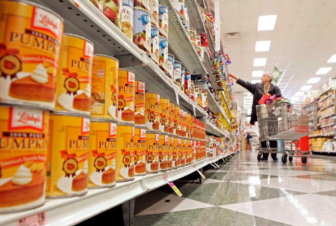 Nedra Zagorski of Rockford heads down the aisle with rows of canned pumpkin Friday, Nov. 19, 2010, at Logli Supermarket on Charles Street in Rockford.