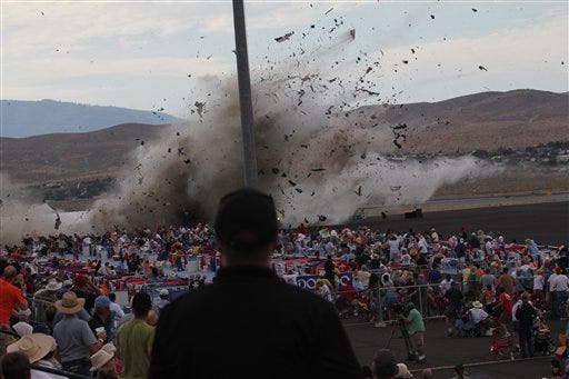 A P-51 Mustang airplane crashes into the edge of the grandstands at the Reno Air show on Friday, Sept. 16, 2011 in Reno Nevada. The World War II-era fighter plane flown by a veteran Hollywood stunt pilot Jimmy Leeward plunged Friday into the edge of the grandstands during the popular air race creating a horrific scene strewn with smoking debris. (AP Photo/Ward Howes)