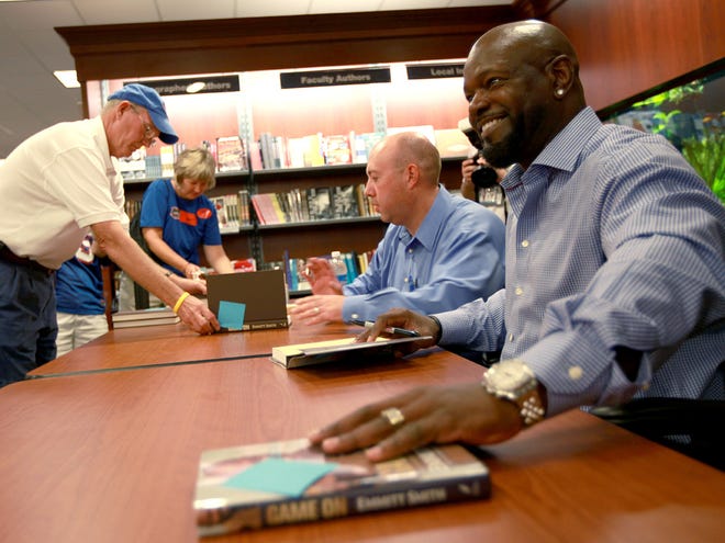Emmitt Smith signs copies of his book at the University Bookstore before the game against the Tennessee Volunteers on Saturday, Sept. 17, 2011 in Gainesville, Fla.