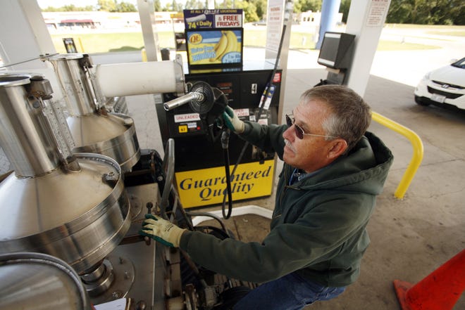 Bob Davis prepares to test a gas pump at the Quick-N-Ez on Toronto Road. Davis pumps five gallons from each pump to ensure it is dispensing the proper amount.
