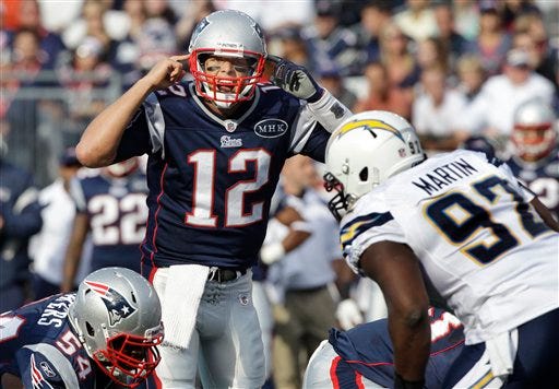Patriots quarterback Tom Brady yells at the line of scrimmage as San Diego Chargers defensive tackle Vaughn Martin prepares for the snap of the ball during the first half of the Patriots' 35-21 victory in Foxboro on Sunday.
