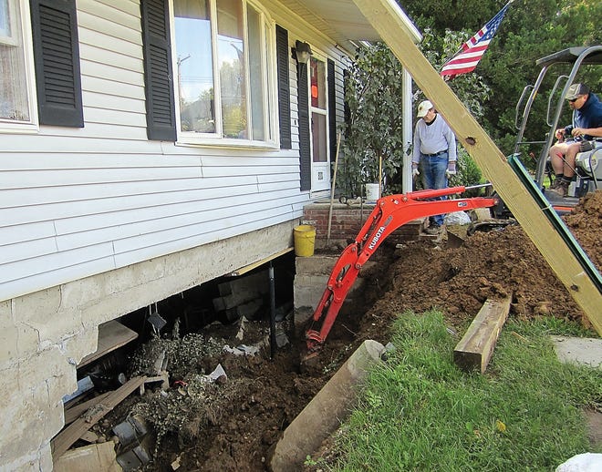 Photo by Jessica Masulli/New Jersey Herald 
Contractor William Teitsma and home owner Jack Leenstra start the process of putting up a temporary wall underneath the Leenstra’s house to stop it from collapsing into the basement. The house on Limecrest Road in Andover Township received significant flooding that caused it to start collapsing.