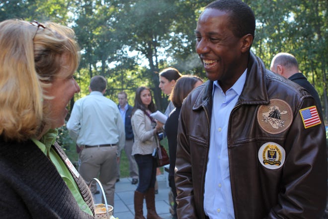 Newton Mayor Setti Warren shares a laugh with Judy White, a member of the Milton Democratic Town Committee, on Sunday, Sept. 18, 2011. At White’s home, Democratic candidates for U.S. Senate talked about the economy, jobs, education and the need to withdraw U.S. troops from Iraq and Afghanistan.