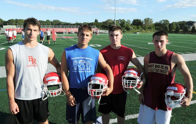 From left, Nick Schlatz, 17, Branden Moxin, 17, Eric DeMoura, 17, and Bradley DeIuliis, 17, during Bridgewater-Raynham Regional High School football practice on August 23, 2011.