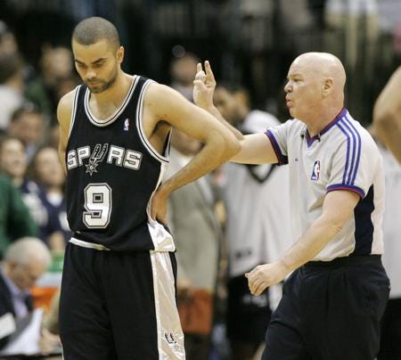 San Antonio Spurs guard Tony Parker looks down as NBA referee
Joey Crawford makes a call during the second half of a 2007 game
against the Dallas Mavericks. Crawford was suspended by
commissioner David Stern in 2007 for his conduct toward Spurs
player Tim Duncan, who contends the official challenged him to a
fight. (AP Photo/Donna McWilliam)