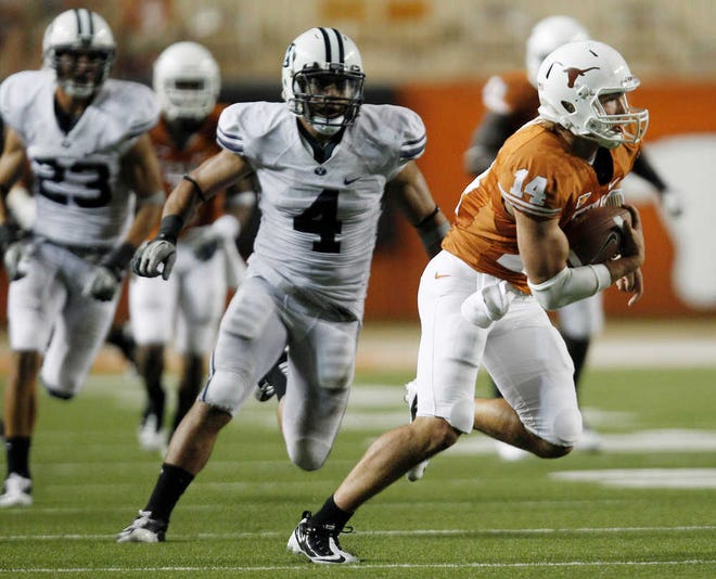 Texas quarterback David Ash (14) is pursued by BYU's Uona Kaveinga (4) after catching a pass from wide receiver Jaxon Shipley.