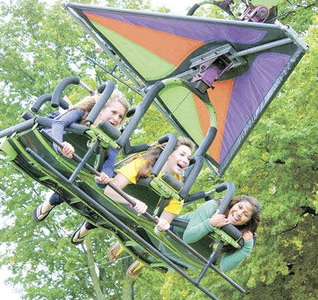 Hannah Ludwick, of Three Rivers, and Kaylara White and Dayana Suarez of Sturgis, rode the Cliff Hanger Monday at Kids’ Day at the St. Joseph County Grange Fair.