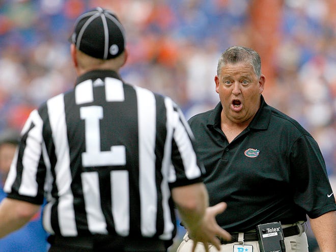 Florida Gators offensive coordinator Charlie Weis talks to the referee against the Tennessee Volunteers during the first half at Ben Hill Griffin Stadium on Saturday, Sept. 17, 2011 in Gainesville, Fla.