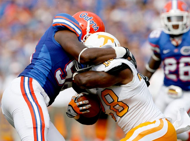 Florida defensive end Will Green tackles Tennessee tailback Tauren Poole during the first half at Ben Hill Griffin Stadium on Saturday, Sept. 17, 2011 in Gainesville, Fla.
