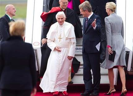 German Chancellor Angela Merkel, left, President Christian Wulff , 2nd from right, and his wife Bettina Wulff, right, welcome Pope Benedict XVI, 2nd from left, as he arrives at the airport Tegel in Berlin, Germany, Thursday, Sept. 22, 2011. Pope Benedict XVI is on a four-day official visit to his homeland Germany.