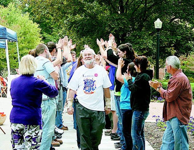 Dr. Jim Stephens, a Hillsdale College philosophy professor and cancer survivor, enjoyed a celebration lap after he spoke at Saturday's Relay For Life event on campus. Sept. 18, 2010.