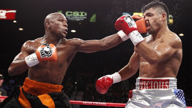 Floyd Mayweather, punching Victor Ortiz, right, in their welterweight bout last week, is winning no fans with his tirade against HBO analyst Larry Merchant and refusal to fight Manny Pacquiao.