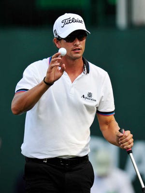 Adam Scott, of Australia, waves after completing his play on the 18th green during the second round of the Tour Championship golf tournament at East Lake Golf Club, Friday, Sept. 23, 2011, in Atlanta. (AP Photo/Rainier Ehrhardt)