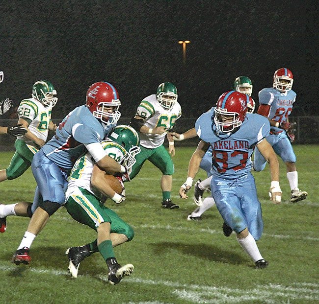 Lakeland’s Devin Dimos (tackling) and Dakota?Becker (83) tackle Eastside running back Lucas Kaiser near the line of scrimmage Friday night in the Lakers?27-0 victory on Homecoming night.