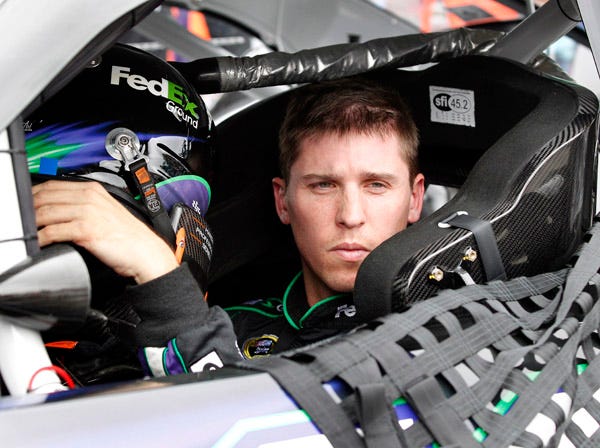 Driver Denny Hamlin looks out from his car at the end of Saturday's practice for today's NASCAR race at New Hampshire Motor Speedway in Loudon, N.H. (Mary Schwalm | Associated Press)