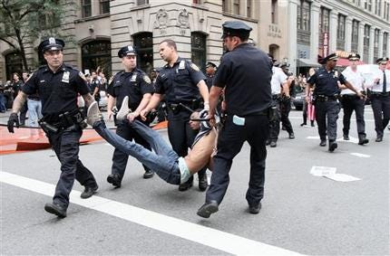 Police carry away a participant in a march organized by Occupy Wall Street in New York on Saturday Sept. 24, 2011. Marchers represented various political and economic causes.