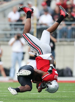 Ohio State quarterback Braxton Miller is upended by Colorado linebacker Douglas Rippy in the second quarter. Miller rushed for 83 yards on 17 carries.