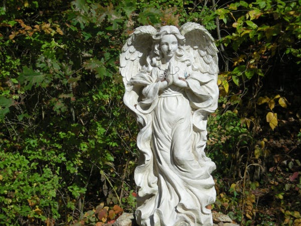 A statue of an angel stands at the trailhead leading to Hosak's Cave.