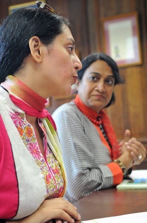 Sadaf Rani, senior producer for Radio Pakistan in Islamabad, left, and Shagufta Ansari, who works for the external publicity wing of the Pakistani government, talk in Easton town hall on Thursday.