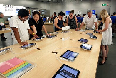 Customers at an Apple store in Carugate, near Milan.