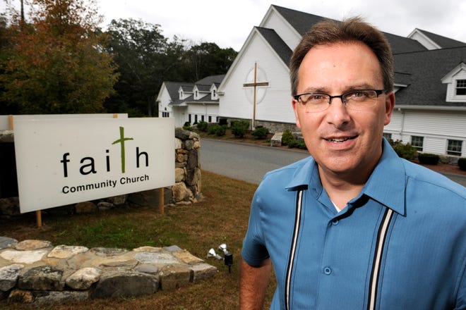 Pastor Mike Laurence stands by the new sign at the Faith Community Church of Hopkinton, formerly the First Congregational Church.
Daily News photo by