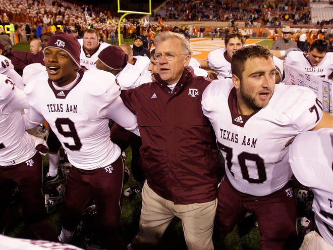 In this Nov. 25, 2010, file photo, Texas A&M coach Mike Sherman, center, sings school songs as he celebrates with his players after defeating Texas in an NCAA college football game, in Austin, Texas. The Southeastern Conference cleared the way for Texas A&M to join its ranks in an announcement Wednesday, Sept. 7, 2011, but with one snag. A Big 12 school has threatened to sue if the Aggies leave the fold. (The Associated Press)