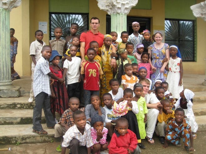 contributed 
 Jonathan Freitag (top row, red shirt) and Sara Shelley (paisley dress), both teachers at Rancocas Valley Regional High School in Mount Holly, traveled to Nigeria in July with the S.E. Onukogu Foundation to teach children English and math and bring medical supplies to those in need.