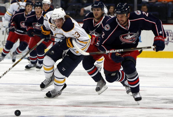 Radek Martinek, right, of Columbus and Tyler Ennis of Buffalo race for the puck in the second period.
