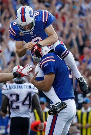 The Bills' Brian Moorman (8) jumps on the shoulders of Rian Lindell after Lindell kicked the game-winning field goal during the Patriots' 34-31 loss on Sunday in Orchard Park, N.Y.