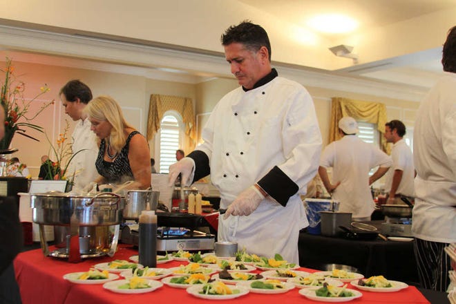 Jim Domanico, a chef at Amici Italian Restaurant, works Sunday at the second annual SAIRA Food and Wine Festival, which gathers together 17 local restaurants and last year raised $13,000 for the local Boys & Girls Club.