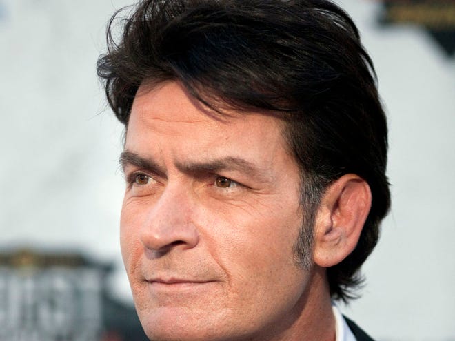 Charlie Sheen is shown on Sept. 10 at the "Comedy Central Roast of Charlie Sheen" in Culver City, Calif. Warner Bros. Television released a statement on Monday, Sept. 26, 2011, saying that Sheen's lawsuit against the studio and series executive producer Chuck Lorre had been settled "to the parties' satisfaction." (AP Photo/Dan Krauss, file)