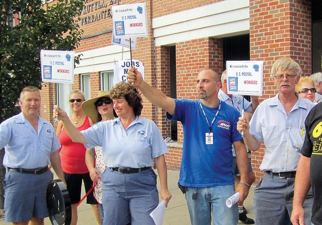 Photo by Steven Reilly/New Jersey Herald
 
Postal carriers protest in front of Rep. Scott Garrett's office on Spring Street in Newton Tuesday.