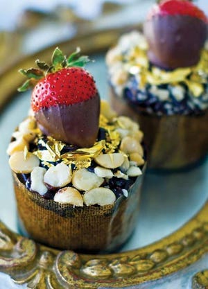 AP Photo/Matthew Mead - Before serving these $16 muffins, sprinkle the macadamia nuts around the outer edge, then sprinkle the gold leaf over the center surface. Top each with a chocolate-covered strawberry.