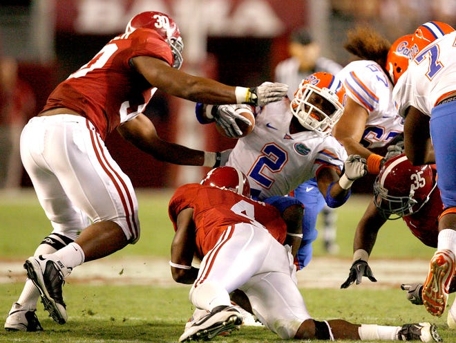 Florida running back Jeff Demps is tackled by Alabama linebacker Dont'a Hightower (30) and Alabama defensive back Mark Barron (4) during the second half on Saturday, Oct. 2, 2010 at Bryant-Denny Stadium.