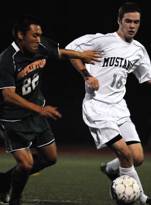Medway's Derek Buckley (right) battles Hopkinton's Josh Hacunda for possession during the Hillers' 3-1 win.