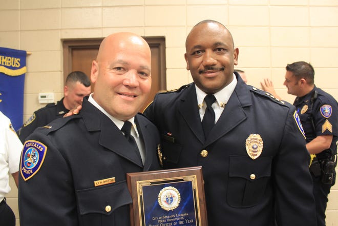 Gonzales Police Officer of the Year Homer Martin receives a plaque from Chief of Police Sherman Jackson.