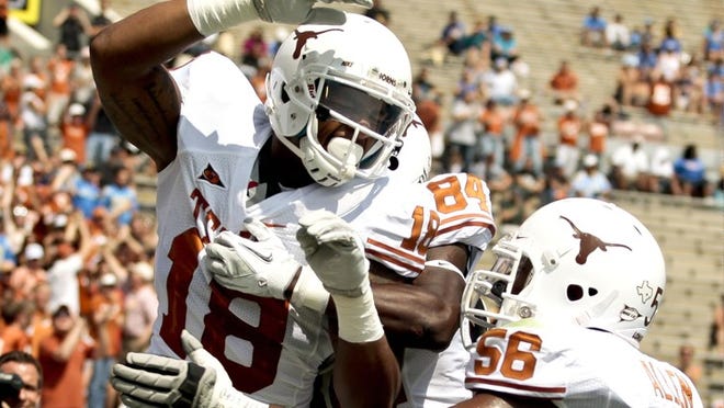 Tight end D.J. Grant (18) celebrates scoring a touchdown against UCLA, one of six catches he had in the Longhorns' 49-20 win.