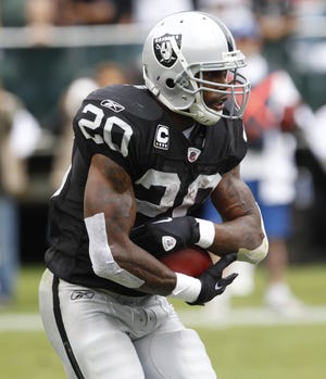 Oakland Raiders running back Darren McFadden carries the ball against the New York Jets in a game in Oakland, Calif., Sunday.